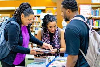 A library outreach event with diverse community members engaging with library staff and resources